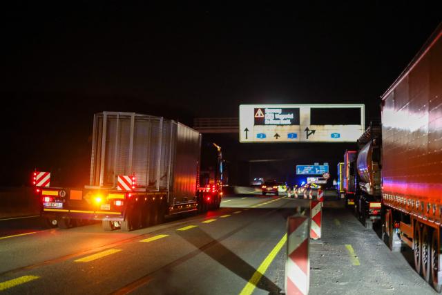 The truck carrying a Castor container for high-level radioactive waste is escorted by police vehicles as it drives on the A3 motorway in Bottrop, western Germany, on March 25, 2026. (Photo by Christoph Reichwein / dpa pool / AFP)