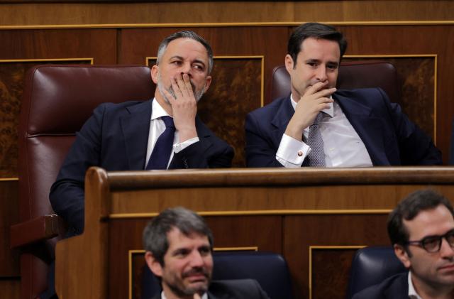 Spain's far-right party Vox leader Santiago Abascal (up, L) looks on after Spain's Prime minister's address to the Parliament over the war in the Middle East at the congress in Madrid on March 25, 2026. Spanish Prime Minister warned that the Middle East war presented a "far worse" scenario than the invasion of Iraq in 2003. (Photo by Thomas COEX / AFP)