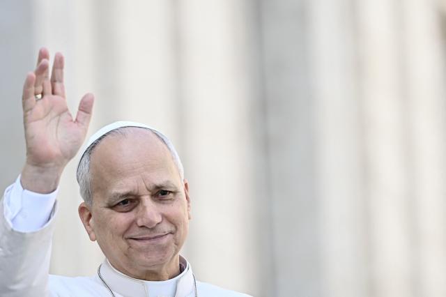Pope Leo XIV waves to the crowd during the weekly general audience at St Peter's Square in The Vatican on March 25, 2026. (Photo by Filippo MONTEFORTE / AFP)