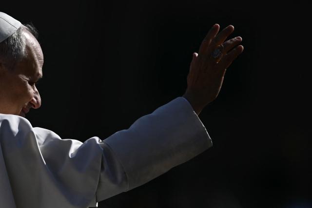 Pope Leo XIV waves to the crowd during the weekly general audience at St Peter's Square in The Vatican on March 25, 2026. (Photo by Filippo MONTEFORTE / AFP)
