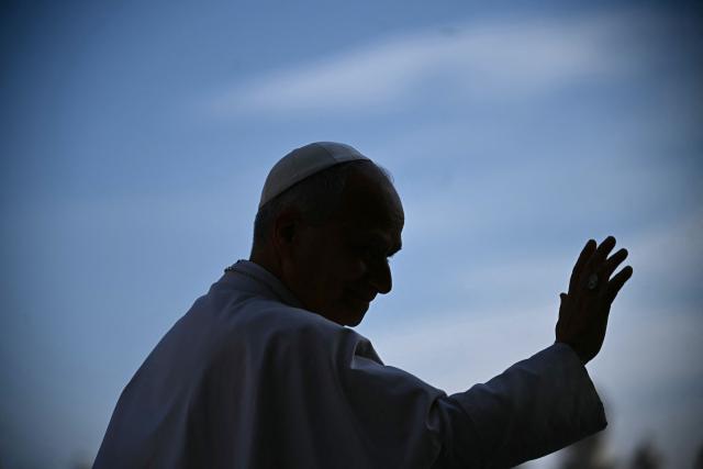 Pope Leo XIV waves to the crowd during the weekly general audience at St Peter's Square in The Vatican on March 25, 2026. (Photo by Filippo MONTEFORTE / AFP)