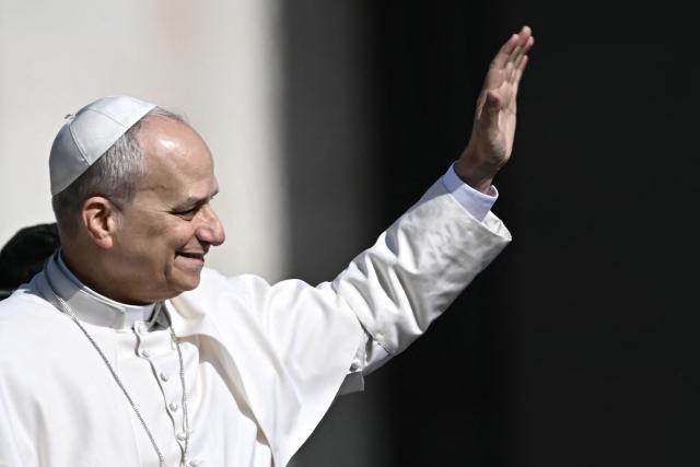 Pope Leo XIV waves to the crowd during the weekly general audience at St Peter's Square in The Vatican on March 25, 2026. (Photo by Filippo MONTEFORTE / AFP)