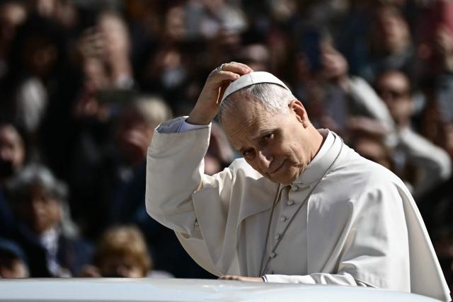 Pope Leo XIV adjusts his skull cap during the weekly general audience at St Peter's Square in The Vatican on March 25, 2026. (Photo by Filippo MONTEFORTE / AFP)