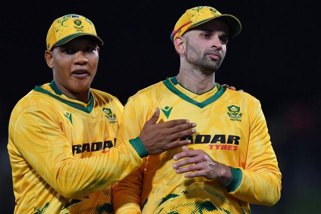 South Africa's Keshav Maharaj (R) and teammate Ottneil Baartman leave the field after winning during the fifth Twenty20 international cricket match between New Zealand and South Africa at Hagley Oval in Christchurch on March 25, 2026. (Photo by Sanka Vidanagama / AFP)