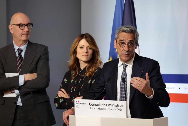 France's Trade Minister Serge Papin addresses journalists next to Government Spokesperson Maud Bregeon and Economy and Finance Minister Roland Lescure during a press conference following the weekly cabinet meeting in Paris on March 25, 2026. (Photo by Ludovic MARIN / AFP)