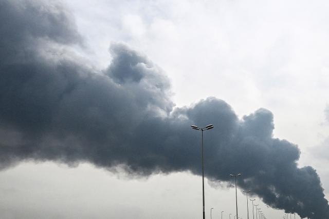 Smoke rises from the area of the Kuwait International Airport after a reported drone strike hit a fuel depot on March 25, 2026. Gulf countries called for Iran to immediately halt its strikes on their territory and provide full reparations, in a rare urgent debate at the UN Human Rights Council on March 25. On February 28, Israel and the United States launched strikes on Iran killing its supreme leader and triggering a war that spread across the Middle East and unleashed chaos across global markets and sent oil prices soaring. (Photo by AFP) / Kuwait OUT / ==Attention editors: AFP covers the war in the Middle East through its extensive regional network, including bureaus in Tehran, Jerusalem, and several neighboring countries. Since the start of the conflict, journalists have been working under increasingly restrictive conditions. Authorities in several countries have limited reporters' movements, photo and live video coverage from sensitive locations. Some governments and armed groups have banned images of missile or drone strikes and other security-related sites. / 