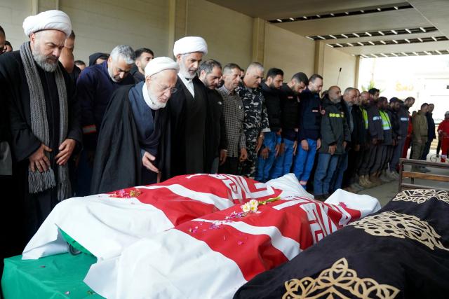 Prayers take place during the funeral of two first aid responders the day after they were killed in an Israeli airstrike, in the southern city of Nabatieh on March 25, 2026. Israel's attacks in Lebanon have killed more than 1,000 people, according to Lebanon's health ministry, and displaced more than a million people. On February 28, Israel and the United States launched strikes on Iran, killing its supreme leader and triggering a war that spread across the Middle East, with Lebanon's Hezbollah entering the fray on March 2. (Photo by Abbas Fakih / AFP)