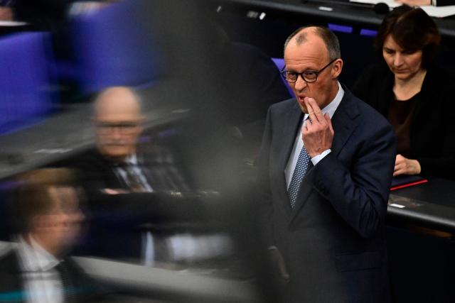 German Chancellor Friedrich Merz gestures as he listens to questions from parliamentarians to the government during a question time at the Bundestag (lower house of parliament) in Berlin, on March 25, 2026. (Photo by John MACDOUGALL / AFP)