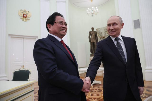 Russian President Vladimir Putin welcomes Vietnamese Prime Minister Pham Minh Chinh during their meeting at the Kremlin in Moscow on March 25, 2026. (Photo by MAXIM SHIPENKOV / POOL / AFP)