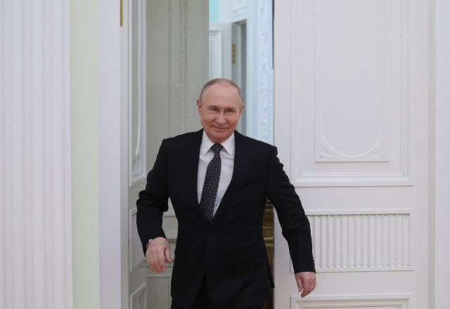 Russian President Vladimir Putin enters a hall for a meeting with Vietnamese Prime Minister at the Kremlin in Moscow on March 25, 2026. (Photo by MAXIM SHIPENKOV / POOL / AFP)