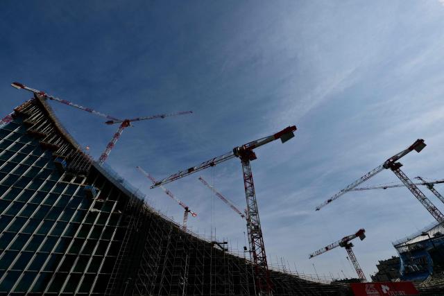 A picture shows the construction site of a new building called "CityWave", a reclining structure which extends horizontally with a large curved wave-shaped roof, covered with a huge photovoltaic park, at the CityLife district of Milan, on March 25, 2026. (Photo by Stefano RELLANDINI / AFP)