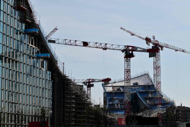 A picture shows the construction site of a new building called "CityWave", a reclining structure which extends horizontally with a large curved wave-shaped roof, covered with a huge photovoltaic park, at the CityLife district of Milan, on March 25, 2026. (Photo by Stefano RELLANDINI / AFP)
