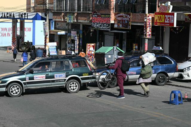 Members of the transport workers union block a street during a strike over the quality of diesel in La Paz, on March 25, 2026. (Photo by AIZAR RALDES / AFP)