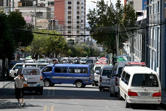 Members of the transport workers union block a street during a strike over the quality of diesel in La Paz, on March 25, 2026. (Photo by AIZAR RALDES / AFP)