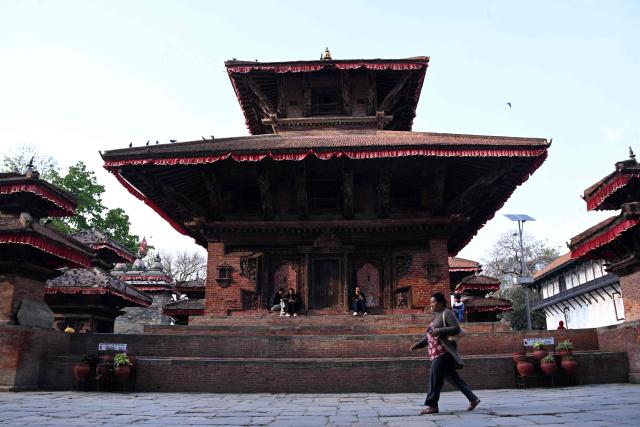Women sit at Durbar Square in Kathmandu on March 25, 2026. (Photo by PRAKASH MATHEMA / AFP)