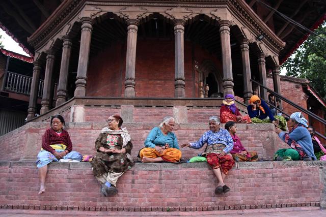 Women sit at Durbar Square in Kathmandu on March 25, 2026. (Photo by PRAKASH MATHEMA / AFP)