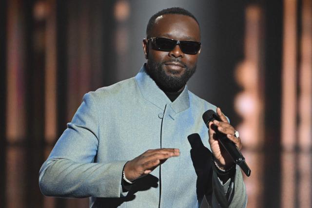 (FILES) Congolese singer Gims celebrates as he receives the Best Male Artist award during the 40th Victoires de la Musique, the annual French music awards ceremony, at the Seine Musicale concert hall in Boulogne-Billancourt, on the outskirts of Paris, on February 14, 2025. Rapper Gims is in police custody in an organized money laundering case announced the organized crime prosecutor’s office on March 25, 2026. (Photo by Bertrand GUAY / AFP)