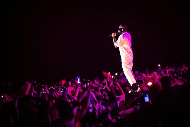(FILES) Congolese singer, rapper, and singer-songwriter GIMS, formerly known as Maоtre Gims performs at the Golden Coast rap festival in Corcelles-les-Monts near Dijon, central eastern France, on September 6, 2025. Rapper Gims is in police custody in an organized money laundering case announced the organized crime prosecutor’s office on March 25, 2026. (Photo by ARNAUD FINISTRE / AFP)