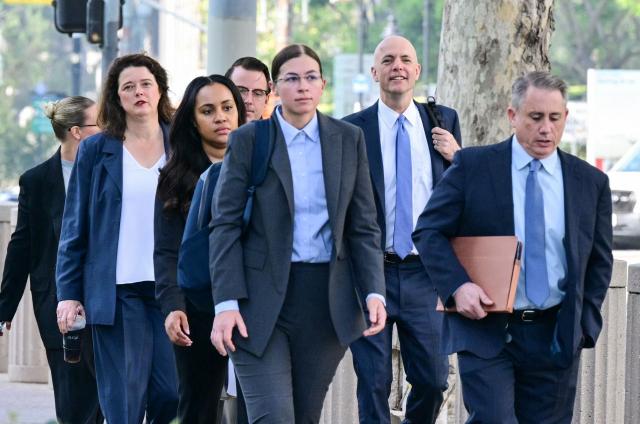 Attorney Paul Schmidt (2R), representing Meta, arrives at Los Angeles Superior Court during the social media trial tasked to determine whether social media giants deliberately designed their platforms to be addictive to children, in Los Angeles, on March 25, 2026. Jurors resumed deliberations on March 24 in a landmark social media trial after signaling that they were having trouble agreeing when it comes to one of the two defendants, Meta and YouTube. (Photo by Frederic J. Brown / AFP)