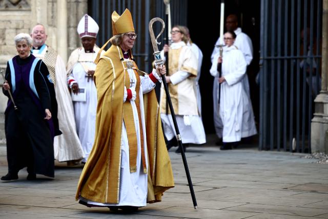 Archbishop of Canterbury Sarah Mullally smiles as she departs following her installation ceremony at Canterbury Cathedral, south-east England on March 25, 2026. The Church of England became Britain's state establishment church following King Henry VIII's split from the Roman Catholic Church in the 1530s. The British monarch is its supreme governor, while the Archbishop of Canterbury is seen as the spiritual leader of Anglicans worldwide. (Photo by Henry NICHOLLS / AFP)