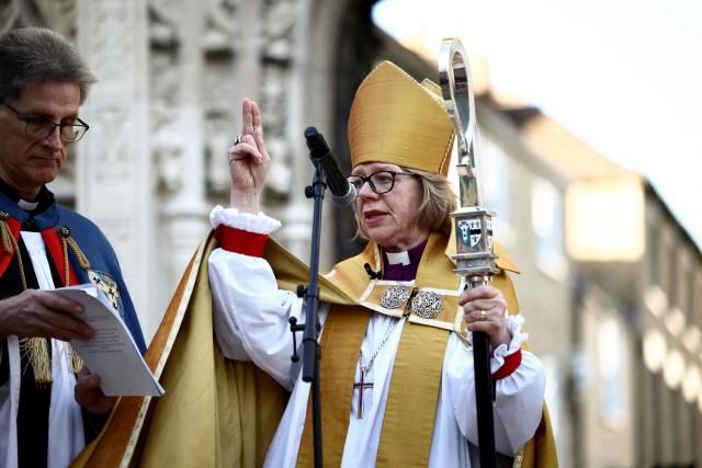 Archbishop of Canterbury Sarah Mullally blesses the crowd at Buttermarket following her installation ceremony at Canterbury Cathedral, south-east England on March 25, 2026. The Church of England became Britain's state establishment church following King Henry VIII's split from the Roman Catholic Church in the 1530s. The British monarch is its supreme governor, while the Archbishop of Canterbury is seen as the spiritual leader of Anglicans worldwide. (Photo by Henry NICHOLLS / AFP)