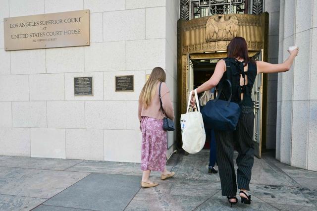 Plaintiff "K.G.M." (L, in floral dress) arrives at Los Angeles Superior Court during the social media trial tasked to determine whether social media giants deliberately designed their platforms to be addictive to children, in Los Angeles, on March 25, 2026. Jurors resumed deliberations on March 24 in a landmark social media trial after signaling that they were having trouble agreeing when it comes to one of the two defendants, Meta and YouTube. (Photo by Frederic J. Brown / AFP)