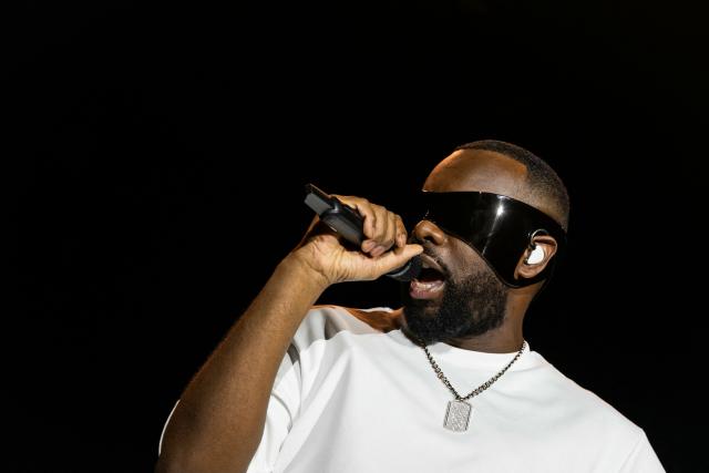 (FILES) Congolese singer, rapper, and singer-songwriter GIMS, formerly known as Maоtre Gims performs at the Golden Coast rap festival in Corcelles-les-Monts near Dijon, central eastern France, on September 6, 2025. Rapper Gims is in police custody in an organized money laundering case announced the organized crime prosecutor’s office on March 25, 2026. (Photo by ARNAUD FINISTRE / AFP)