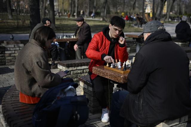 People play chess at a park in central Kyiv on March 25, 2026, amid the Russian invasion of Ukraine. (Photo by Genya SAVILOV / AFP)