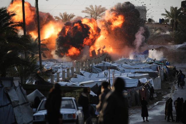 A fireball erupts following an Israeli strike near a tent encampment sheltering people displaced by war in Deir el-Balah in the central Gaza Strip on March 25, 2026. Violence has persisted in Gaza despite a ceasefire which came into effect on October 10, with both Israel and Hamas regularly accusing each other of violations. (Photo by Eyad BABA / AFP)