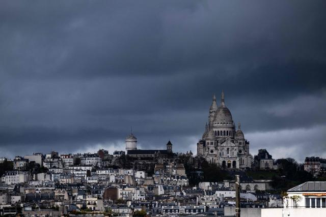 This photograph shows the Sacre Coeur Basilica on Montmartre hill before a storm in Paris on March 25, 2026. (Photo by Blanca CRUZ / AFP)