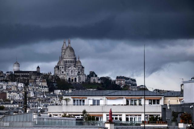 This photograph shows the Sacre Coeur Basilica on Montmartre hill before a storm in Paris on March 25, 2026. (Photo by Blanca CRUZ / AFP)