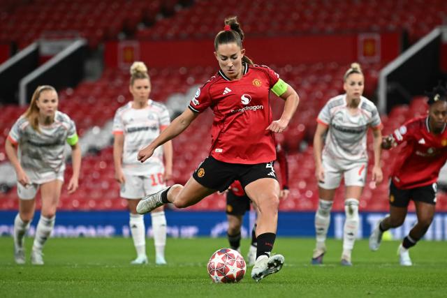 Manchester United's English defender #04 Maya Le Tissier (C) takes a penalty to score Manchester United's first goal during the UEFA Women's Champions League, Quarter Final first-leg football match between Manchester United and Bayern Munich at Old Trafford in Manchester, north west England, on March 25, 2025. (Photo by Paul ELLIS / AFP)