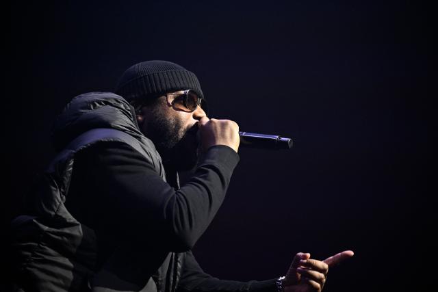 French rapper Lino performs on stage during a concert in tribute to French late rapper Werenoi at the Accor Arena in Paris on March 25, 2026. (Photo by JULIEN DE ROSA / AFP)