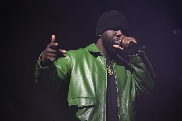 French rapper Dinos performs on stage during a concert in tribute to French late rapper Werenoi at the Accor Arena in Paris on March 25, 2026. (Photo by JULIEN DE ROSA / AFP)