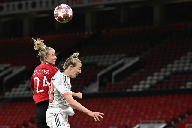 Manchester United's German forward #24 Lea Schuller (L) and Bayern Munich's German defender #30 Carolin Simon (R) fight for the ball in the air during the UEFA Women's Champions League, Quarter Final first-leg football match between Manchester United and Bayern Munich at Old Trafford in Manchester, north west England, on March 25, 2025. (Photo by Paul ELLIS / AFP)