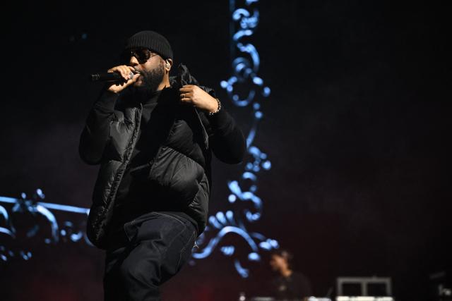 French rapper Lino performs on stage during a concert in tribute to French late rapper Werenoi at the Accor Arena in Paris on March 25, 2026. (Photo by JULIEN DE ROSA / AFP)