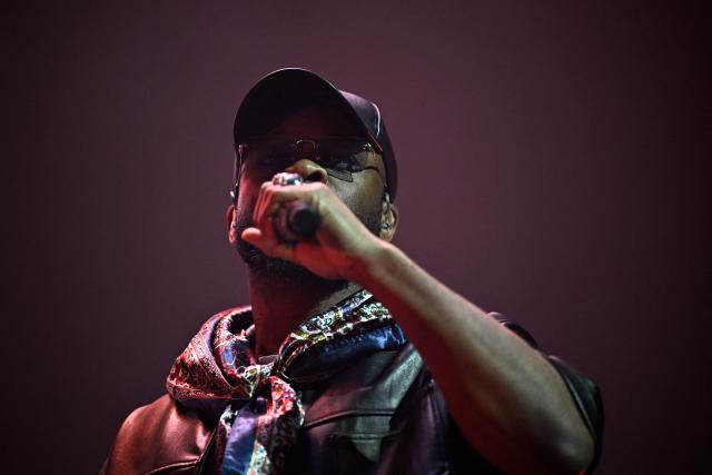 French rapper Dosseh performs on stage during a concert in tribute to French late rapper Werenoi at the Accor Arena in Paris on March 25, 2026. (Photo by JULIEN DE ROSA / AFP)