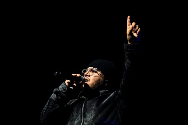 Belgian rapper Hamza performs on stage during a concert in tribute to French late rapper Werenoi at the Accor Arena in Paris on March 25, 2026. (Photo by JULIEN DE ROSA / AFP)