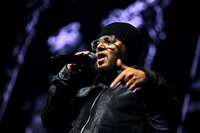 Belgian rapper Hamza performs on stage during a concert in tribute to French late rapper Werenoi at the Accor Arena in Paris on March 25, 2026. (Photo by JULIEN DE ROSA / AFP)