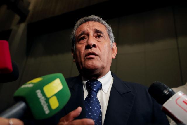 Peru's presidential candidate Mesias Guevara, for the Morado party, speaks to the media as he arrives at the third round of debates on tackling crime and corruption at the Lima Convention Center in Lima on March 25, 2026. Peru will hold presidential elections on April 12. (Photo by Connie FRANCE / AFP)