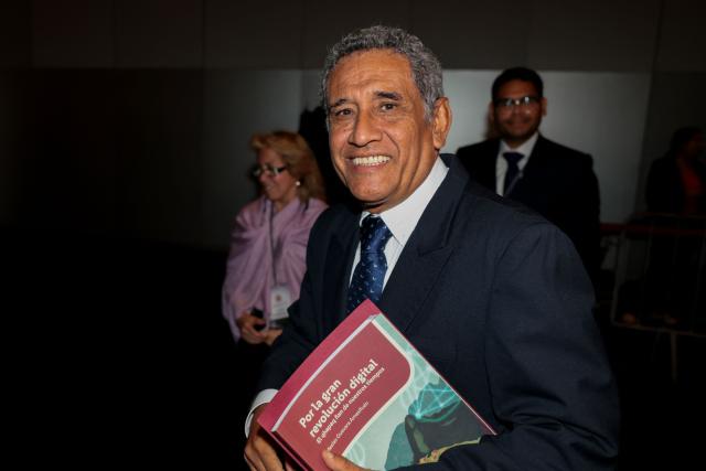 Peru's presidential candidate Mesias Guevara, for the Morado party, smiles as he arrives at the third round of debates on tackling crime and corruption at the Lima Convention Center in Lima on March 25, 2026. Peru will hold presidential elections on April 12. (Photo by Connie FRANCE / AFP)