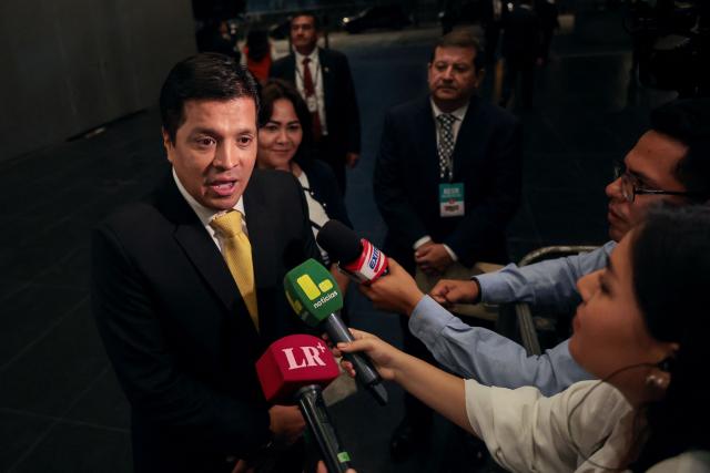 Peru's presidential candidate Paul Jaimes, for the Progresemos party, speaks to the media as he arrives at the third round of debates on tackling crime and corruption at the Lima Convention Center in Lima on March 25, 2026. Peru will hold presidential elections on April 12. (Photo by Connie FRANCE / AFP)