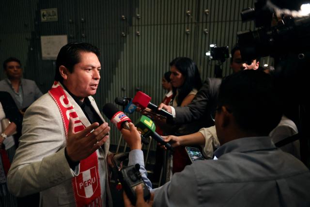 Peru's presidential candidate Herbert Caller, for the Patriotic Party of Peru, speaks to the media as he arrives at the third round of debates on tackling crime and corruption at the Lima Convention Center in Lima on March 25, 2026. Peru will hold presidential elections on April 12. (Photo by Connie FRANCE / AFP)