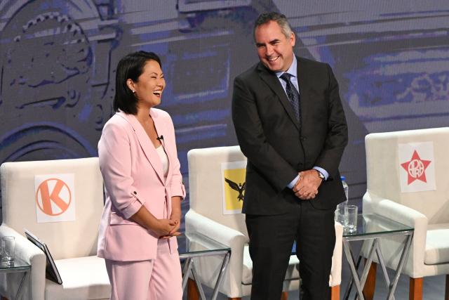 Peru's presidential candidate Keiko Fujimori (L), for the Fuerza Popular party, and Rafael Belaunde (R), for the Popular Liberty party, talk each other during the third round of debates on tackling crime and corruption at the Lima Convention Center in Lima on March 25, 2026. Peru will hold presidential elections on April 12. (Photo by ERNESTO BENAVIDES / AFP)