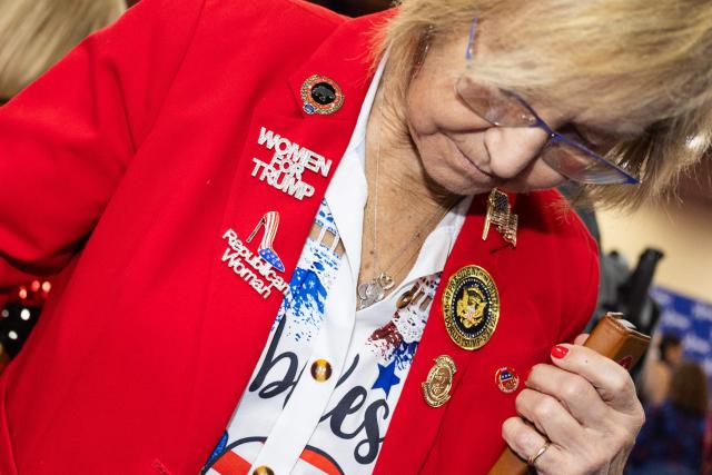An attendee walks through the exhibition hall during the Conservative Political Action Conference, at the Gaylord Texan Resort & Convention Center, in Grapevine, Texas, on March 25, 2026. American conservatives converge on Texas this week for what organizers bill as their largest and most influential gathering, with the Iran war and fears of a punishing midterm election cycle heightening the stakes. (Photo by Leandro Lozada / AFP)