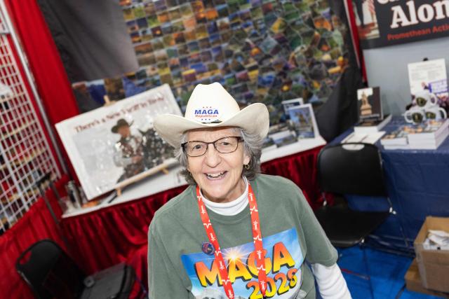 A vendor wearing “Trump” and “MAGA” paraphernalia is pictured at the Conservative Political Action Conference at the Gaylord Texan Resort & Convention Center in Grapevine, Texas, on March 25, 2026. American conservatives converge on Texas this week for what organizers bill as their largest and most influential gathering, with the Iran war and fears of a punishing midterm election cycle heightening the stakes. (Photo by Leandro Lozada / AFP)