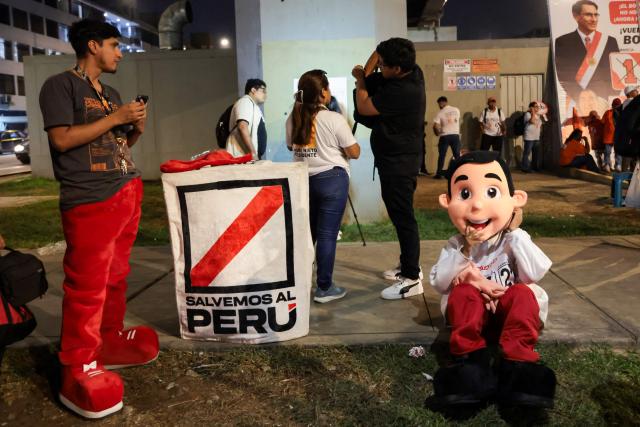 Supporters of Peru's presidential candidate Antonio Ortiz, for the Salvemos Al Peru party, gather during the third round of debates on tackling crime and corruption at the Lima Convention Center in Lima on March 25, 2026. Peru will hold presidential elections on April 12. (Photo by Connie FRANCE / AFP)
