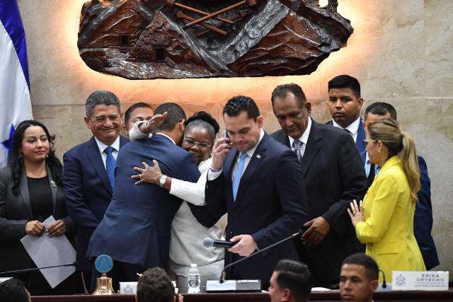 Members of the Honduran Congress’ board of directors congratulate the country’s new Attorney General, Pablo Emilio Reyes Theodore (C), in Tegucigalpa on March 25, 2026. Honduras’ Congress, controlled by the right, suspended Attorney General Johel Zelaya on the night of March 23, 2026. Zelaya, who is close to the previous leftist government, was removed to face an impeachment trial on accusations of abuse of authority and persecution during last November’s elections. (Photo by Orlando SIERRA / AFP)