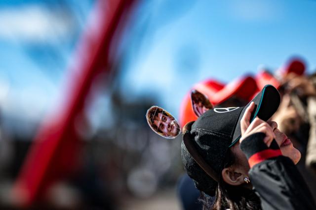 A fan wears a decorative hat with the portraits her supporting drivers ahead of the Formula One Japanese Grand Prix in Suzuka on March 26, 2026. (Photo by Philip FONG / AFP)