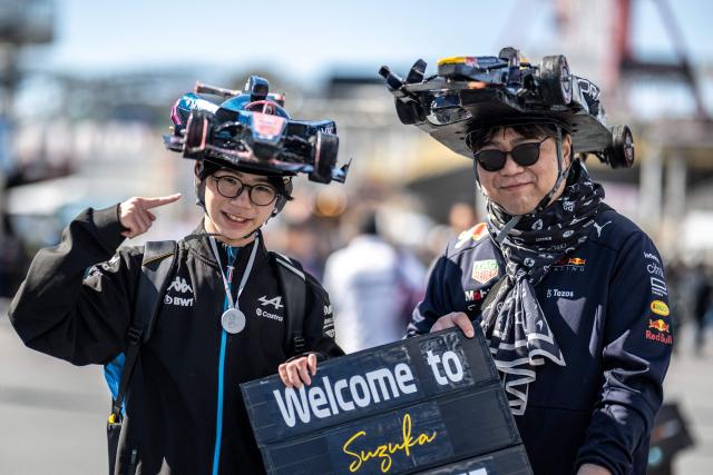 Fans wearing decorative hats ahead of the Formula One Japanese Grand Prix in Suzuka on March 26, 2026. (Photo by Philip FONG / AFP)